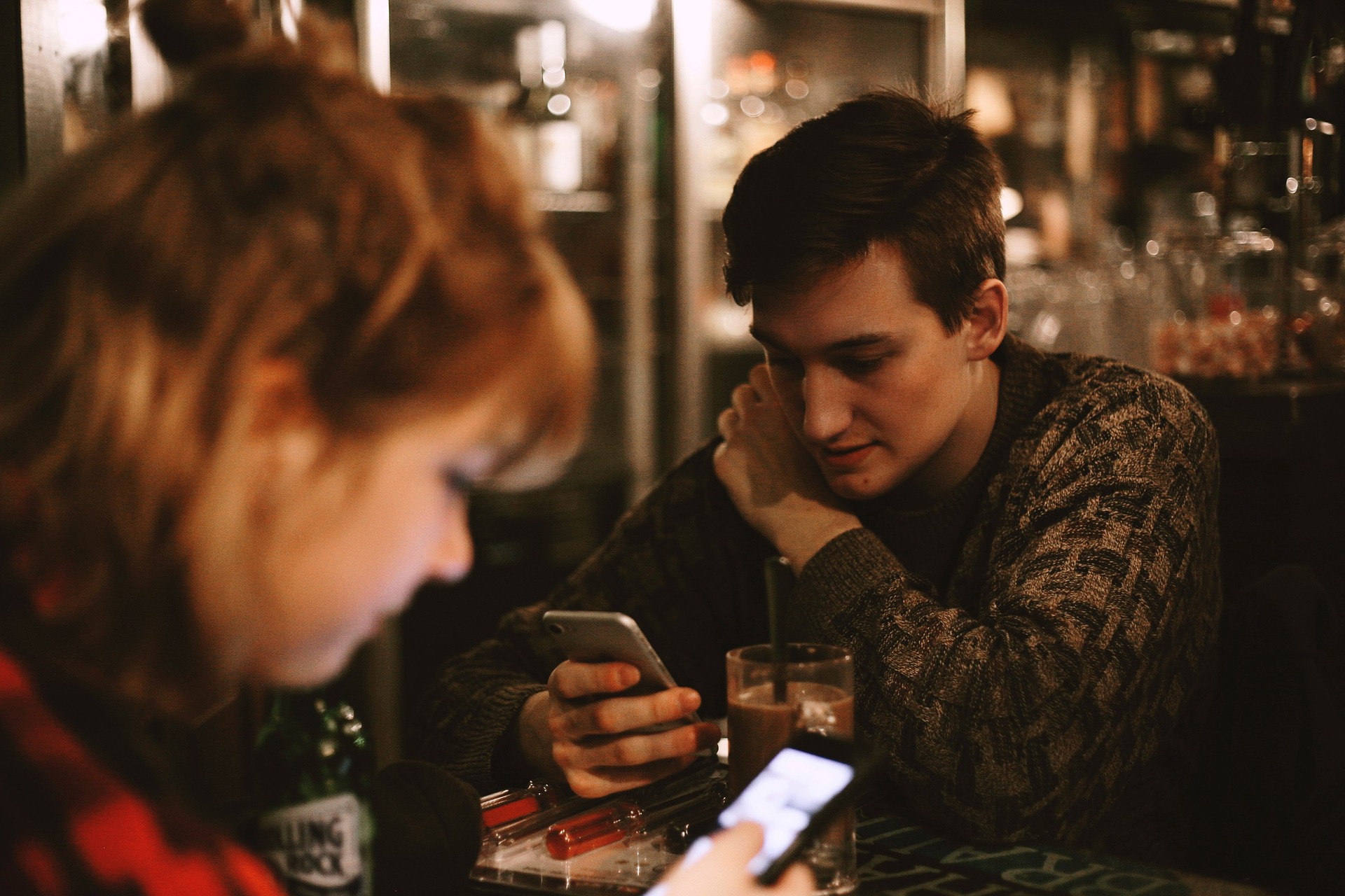 teens texting at table