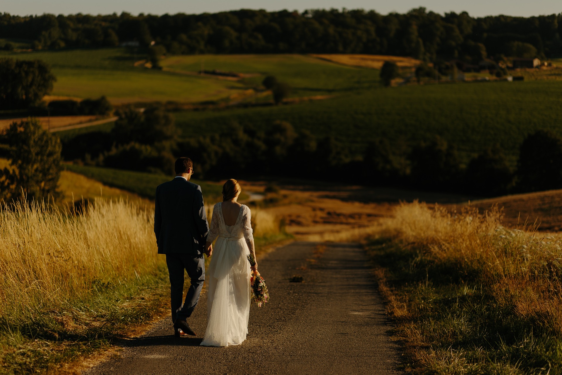 bride and groom walking on road